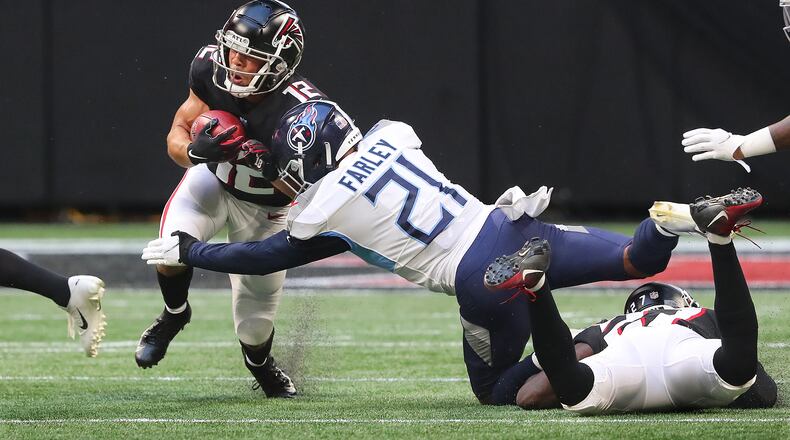 Falcons wide receiver Chris Rowland returns a punt against the Tennessee Titans - with safety Matthias Farley making the tackle - during the first half of first exhibition game Friday, Aug. 13, 2021, at Mercedes-Benz Stadium in Atlanta. (Curtis Compton / Curtis.Compton@ajc.com)