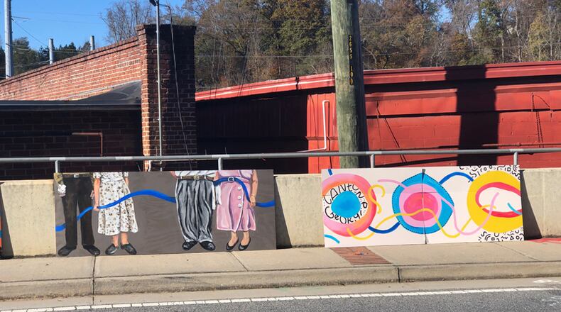 Excepts from a planned mural are shown along the Railroad Street wall in Canton that will be the canvas for Shanna Coulter's "legs through history."