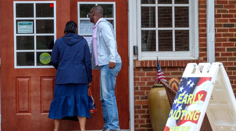 People walk into the Johns Creek early voting polling location on March 14, 2020. STEVE SCHAEFER / SPECIAL TO THE AJC