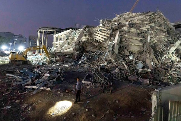 FILE- Rescuers search for victims at the site of a high-rise building under construction that collapsed after a strong earthquake in Bangkok, Thailand, early Saturday, March 29, 2025. (AP Photo/Wason Wanichakorn, File)
