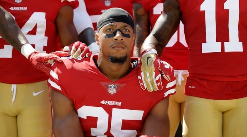 San Francisco 49ers safety Eric Reid (35) kneels in front of teammates during the playing of the national anthem before an NFL football game between the 49ers and the Carolina Panthers in Santa Clara, Calif., Sunday, Sept. 10, 2017. (AP Photo/Marcio Jose Sanchez)