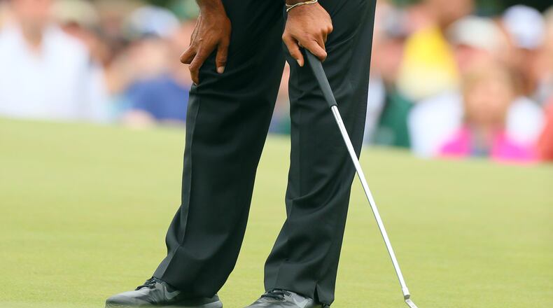 Tiger Woods reacts to missing his birdie putt on No. 1 green.