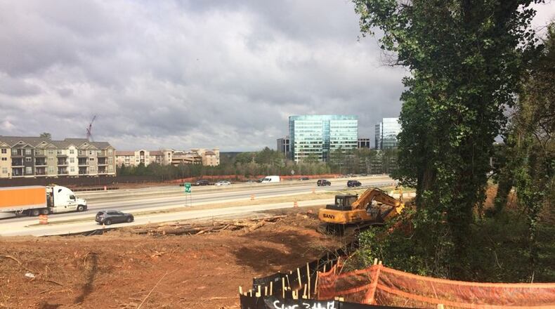 Trees are cleared from alongside Ga. 400 as part of the reconstruction of its interchange with I-285 in the Sandy Springs-Dunwoody-Brookhaven area. AJC FILE