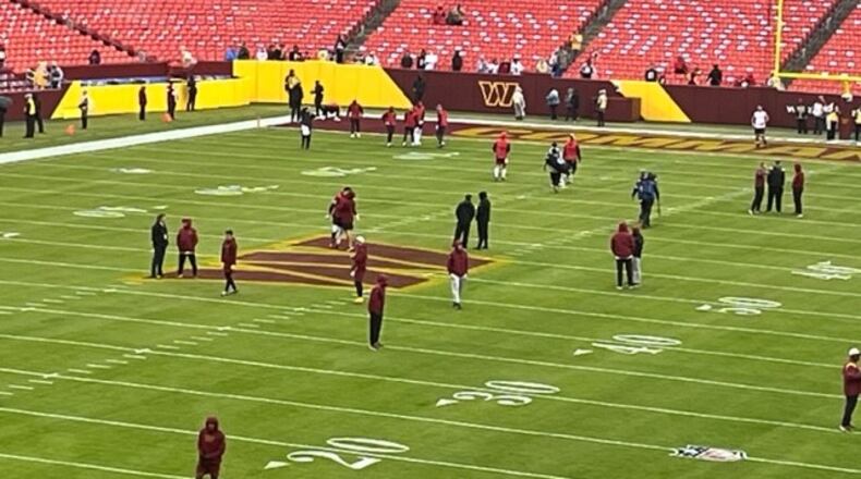The Commanders and the Falcons warming up at FedEx Field on Sunday. (By D. Orlando Ledbetter/dledbetter@ajc.com)