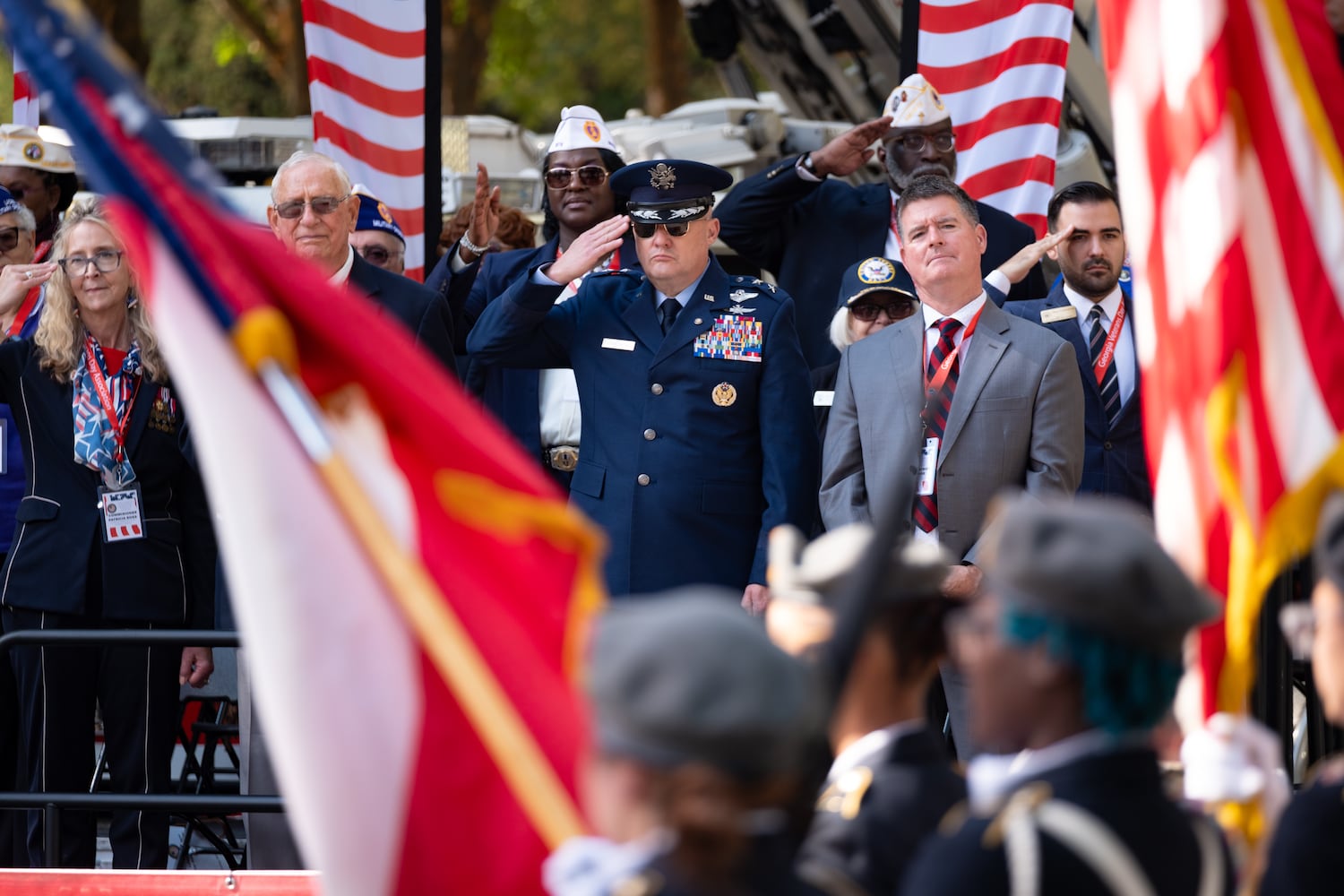 Dignitaries on the reviewing stand each a JROTC group march past during the Georgia Veterans Day Parade in Midtown Atlanta on Saturday, Nov. 8, 2025.   Ben Gray for the Atlanta Journal-Constitution