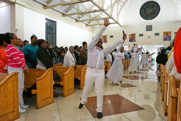Members of the "mimers" youth group dance as they process before Mass into Notre Dame d'Haiti Catholic church Saturday, March 29, 2025, in Miami. (AP Photo/Giovanna Dell'Orto)