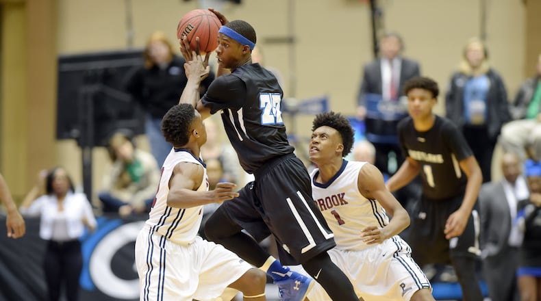 Raquan Wilkins (22) of Westlake splits Pebblebrook defenders Jared Harper (11) and Collin Sexton (1) in the Class AAAAAA boys championship at the Macon Coliseum on Saturday, March 5, 2016. KENT D. JOHNSON/ kdjohnson@ajc.com