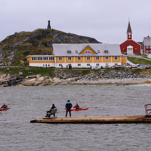 FILE - Tourists kayak at sea in front of Nuuk Cathedral in Nuuk, Greenland, June 16, 2025. (AP Photo/Kwiyeon Ha, File)