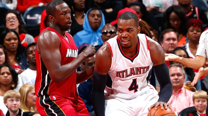 ATLANTA, GA - MARCH 27: Paul Millsap #4 of the Atlanta Hawks drives against Luol Deng #9 of the Miami Heat at Philips Arena on March 27, 2015 in Atlanta, Georgia. NOTE TO USER: User expressly acknowledges and agrees that, by downloading and/or using this photograph, user is consenting to the terms and conditions of the Getty Images License Agreement. (Photo by Kevin C. Cox/Getty Images) Paul Millsap, who had 21 points and nine rebounds against Miami, has been Hawks' best player. (Kevin C. Cox, Getty Images)