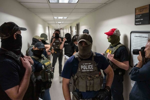 Federal agents stand outside immigration court at the Jacob K. Javits Federal Building, Wednesday, July 16, 2025, in New York. (AP Photo/Yuki Iwamura)