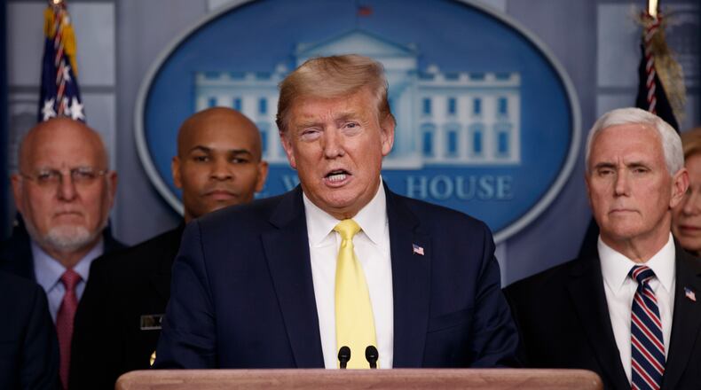 In this March 9, 2020, photo, President Donald Trump speaks in the briefing room of the White House in Washington about the coronavirus outbreak as Dr. Robert Redfield, director of the Centers for Disease Control and Prevention, Surgeon General Jerome Adams and Vice President Mike Pence, listen. (AP Photo/Carolyn Kaster, File)