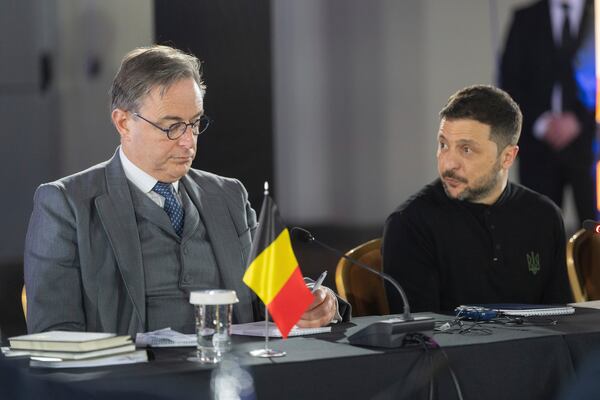 Belgium's Prime Minister Bart de Wever, left, and Ukrainian President Volodymyr Zelenskyy talk with Belgium and Ukrainian officials and businessmen in Kyiv, Ukraine, Tuesday, April 8, 2025. (AP Photo/Efrem Lukatsky)