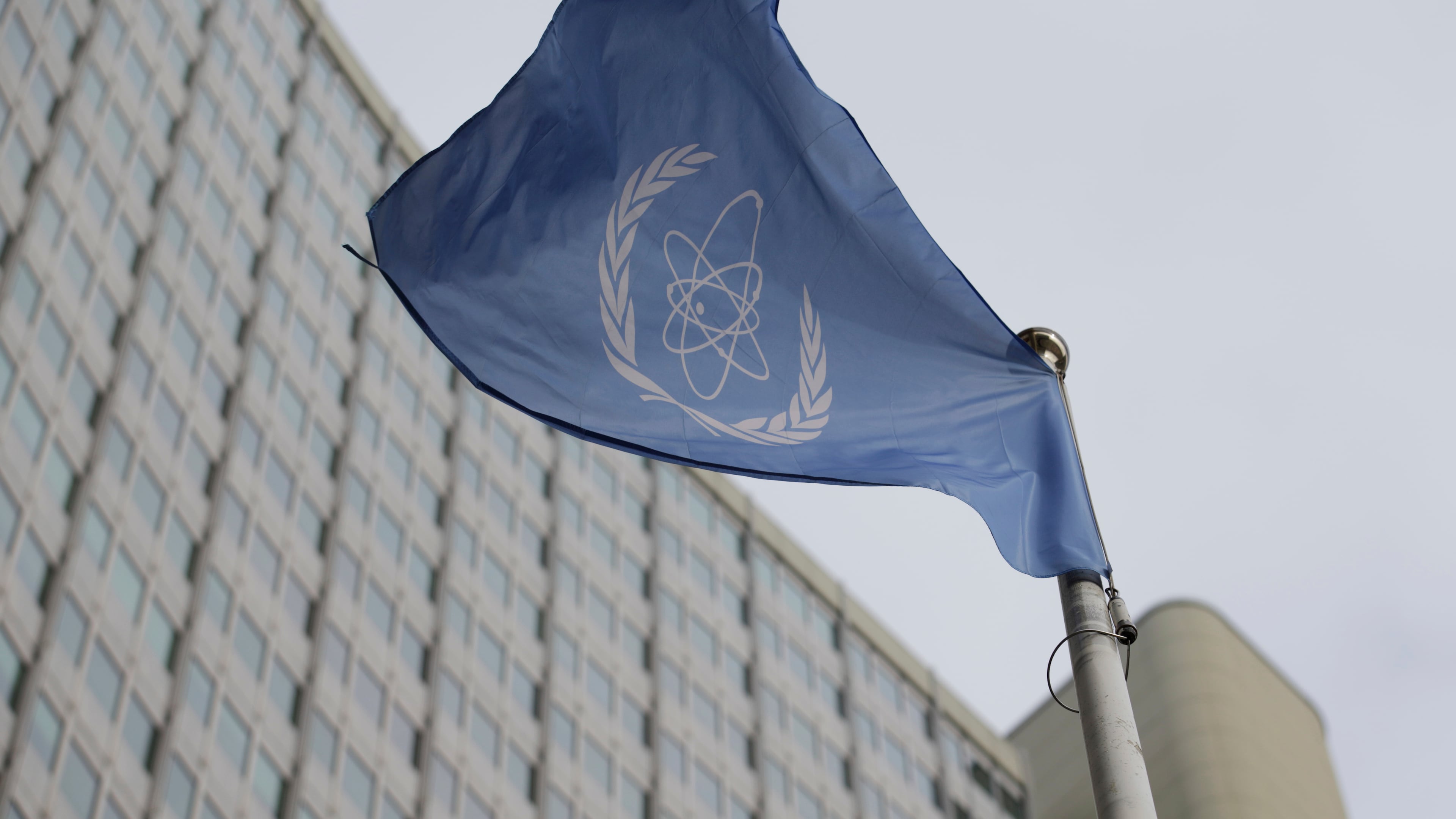 FILE - The flag of the International Atomic Energy Agency flies in front of its headquarters during an IAEA Board of Governors meeting in Vienna, Austria, on Feb. 6, 2023. (AP Photo/Heinz-Peter Bader, File)