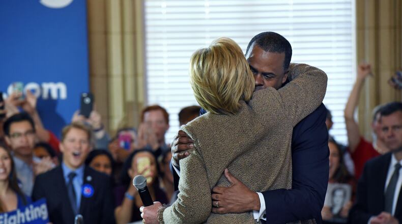 Hillary Clinton hugs Atlanta Mayor Kasim Reed during a Clinton campaign event at Atlanta City Hall Feb. 26. HYOSUB SHIN / HSHIN@AJC.COM