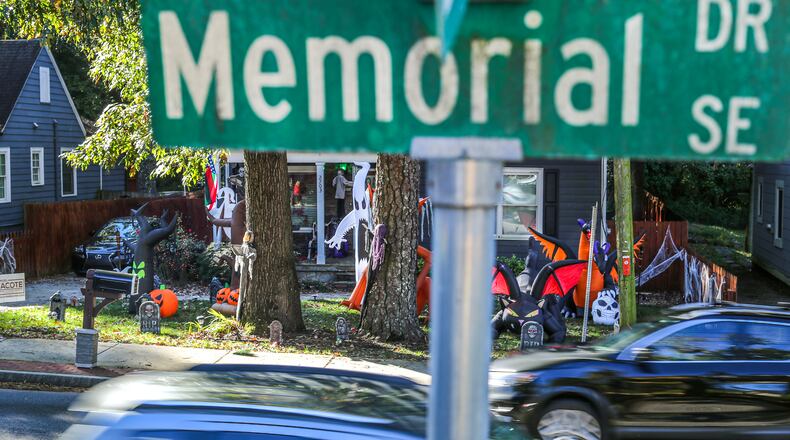 November 1, 2021 Atlanta: Traffic speeds by Halloween decorations displayed along the 2700 block of Memorial drive Monday, Nov. 1, 2021 near the area where an 11-year-old boy was killed on Halloween night after he was hit by a car in the East Lake neighborhood of southeast Atlanta. The child was trick-or-treating with friends on Memorial Drive near East Lake Golf Club when he was struck about 8:20 p.m. Sunday, according to Atlanta police. He was taken to a hospital, where he was pronounced dead. (John Spink / John.Spink@ajc.com)