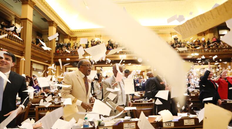 State representatives throw paper in the air to celebrate the end of the legislative session at the Georgia State Capitol in Atlanta, Georgia on Tuesday, April 2, 2019. EMILY HANEY / emily.haney@ajc.com