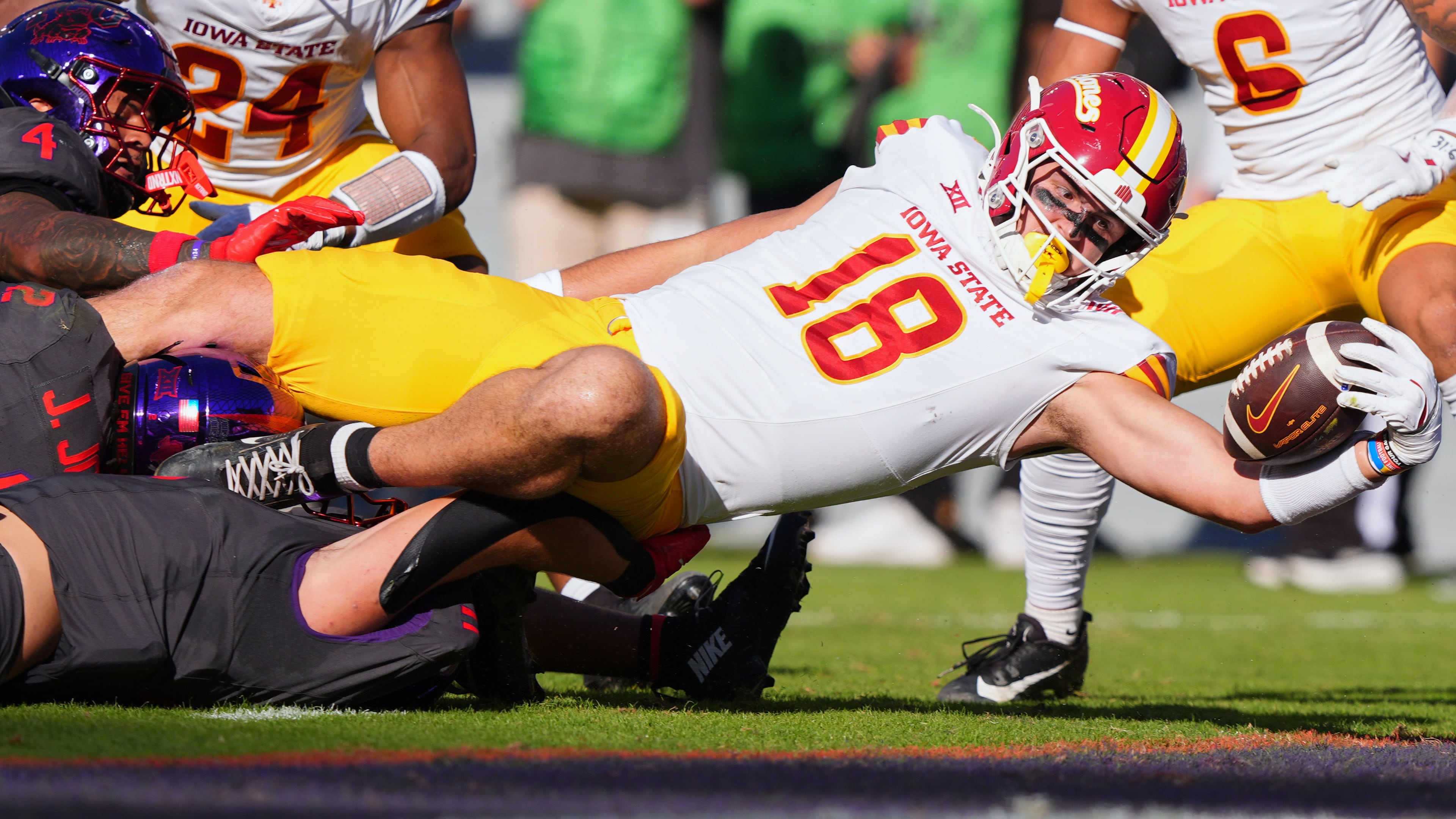 Iowa State tight end Benjamin Brahmer (18) scores a touchdown against TCU defenders Vernon Glover (26), Jamel Johnson (2) and Devean Deal (11) during the first half of an NCAA college football game Saturday, Nov. 8, 2025, in Fort Worth, Texas. (AP Photo/LM Otero)