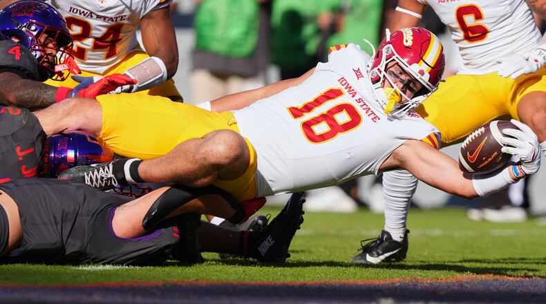 Iowa State tight end Benjamin Brahmer (18) scores a touchdown against TCU defenders Vernon Glover (26), Jamel Johnson (2) and Devean Deal (11) during the first half of an NCAA college football game Saturday, Nov. 8, 2025, in Fort Worth, Texas. (AP Photo/LM Otero)