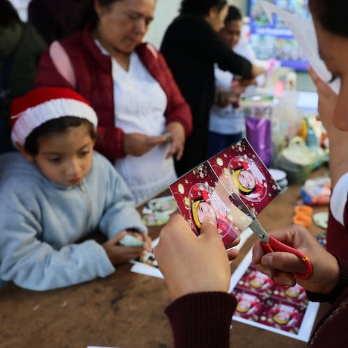 Sister Maria Elena cuts a photograph of a missing girl to paste on a Christmas ornament to hang on the Tree of Hope, during an event organized by the diocese of Ecatepec at the Church of the Sacred Heart of San Cristobal in Ecatepec, State of Mexico, Monday, Nov. 17, 2025. (AP Photo/Ginnette Riquelme)