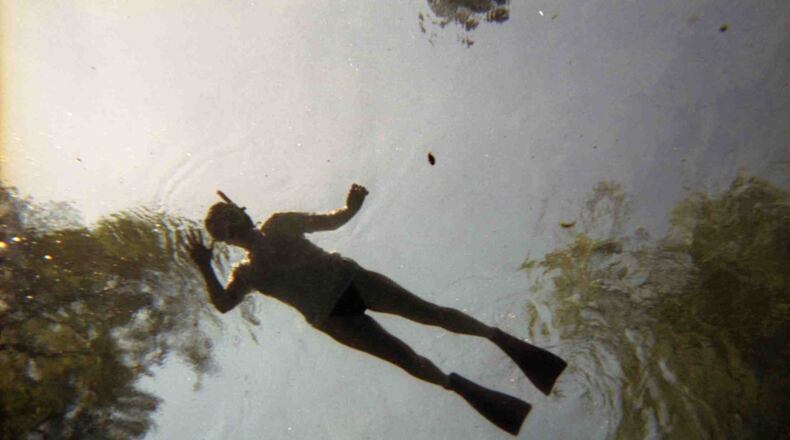 "This is a picture taken many years ago while snorkeling in Ginny Springs, Florida," wrote Davis Byrd.."This is looking up at my wife who is floating on the surface, but it looks like she is suspended in the sky.