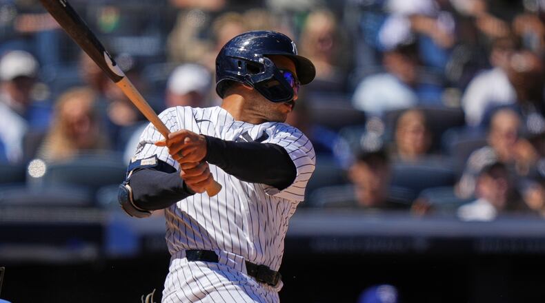 New York Yankees' Trent Grisham follows through on a three-run double during the sixth inning of a baseball game against the Texas Rangers Thursday, May 7, 2026, in New York. (AP Photo/Frank Franklin II)