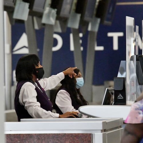 Delta Air Lines employees work the ticket counter in the domestic terminal at Hartsfield-Jackson Atlanta International Airport on Tuesday, Oct. 5, 2021. (Hyosub Shin/AJC)