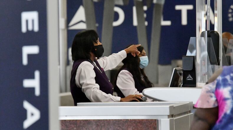 Delta Air Lines employees work the ticket counter in the Domestic Terminal at Hartsfield-Jackson Atlanta International Airport in Atlanta.
Delta  Air Lines said 90% of its employees are now vaccinated against  COVID-19. (Hyosub Shin / Hyosub.Shin@ajc.com)