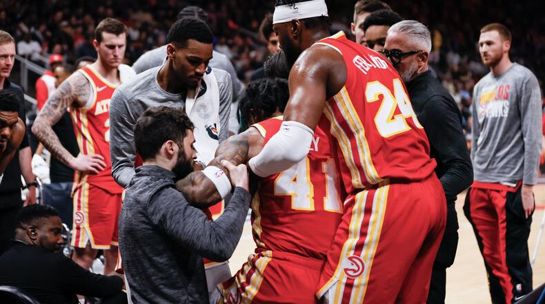 Atlanta Hawks forward Saddiq Bey (41) is getting help from doctors and teammates after injuring his leg during the second half of the game against the New Orleans Pelicans at State Farm Arena on Sunday, March 10, 2024, in Atlanta.
 Miguel Martinez / miguel.martinezjimenez@ajc.com