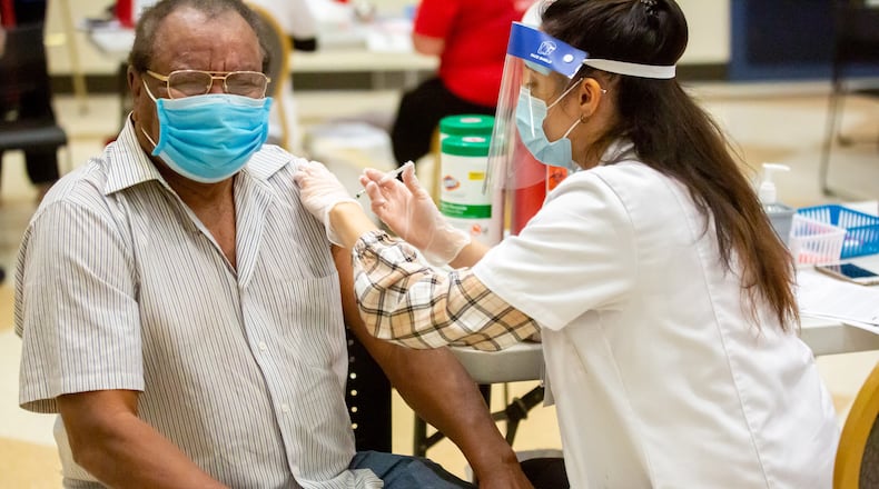 A Walgreens employee gives John Brown a vaccination shot at St. Philip AME Church in Atlanta Saturday, March 13, 2020. (Steve Schaefer for The Atlanta Journal-Constitution)