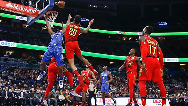 Orlando Magic forward Jonathon Simmons (17) shoots after driving past Atlanta Hawks forward John Collins (20) as Hawks guard Tyler Dorsey (2), forward Taurean Prince (12), guard Dennis Schroder (17) and Magic center Bismack Biyombo (11) look on during the second quarter of an NBA basketball game in Orlando, Fla., on Thursday, Feb. 8, 2018. (AP Photo/Reinhold Matay)