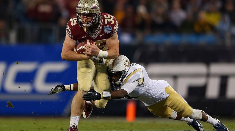 Jamal Golden #4 of the Georgia Tech Yellow Jackets attempts a diving tackle against Nick O'Leary #35 of the Florida State Seminoles in the 2nd half during the ACC Championship game on December 6, 2014 in Charlotte, North Carolina. (Photo by Mike Ehrmann/Getty Images)