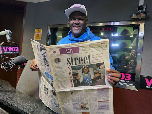 Greg Street at V-103 studios with the very first article in The Atlanta Journal-Constitution written about him when he arrived in 1995. (Rodney Ho/AJC) 
