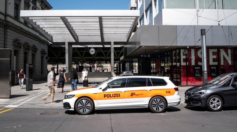 A police vehicle is parked in front of Winterthur train station following a stabbing attack in Winterthur, Switzerland, Thursday, May 28, 2026. (Claudio Thoma/Keystone via AP)