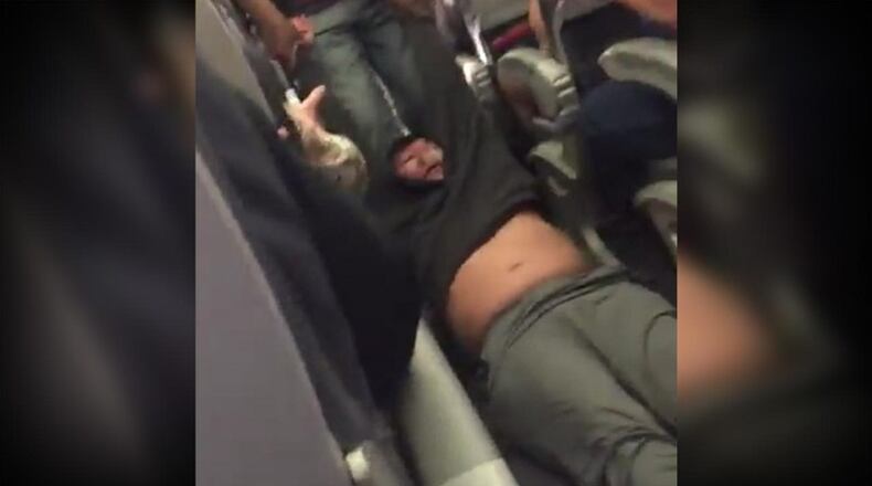 This Sunday, April 9, 2017, image made from a video provided by Audra D. Bridges shows a passenger being removed from a United Airlines flight in Chicago.