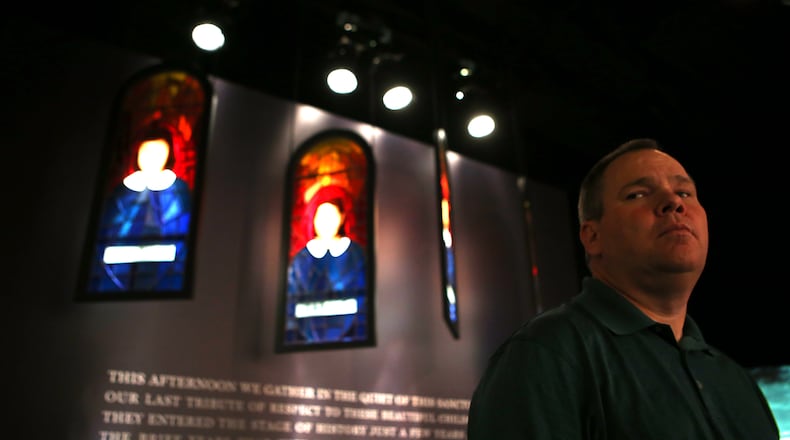 Gwinnett County Commissioner Tommy Hunter, seen here with a memorial to the four girls killed in a 1963 church bombing in Birmingham, Alabama, and his colleagues on the Board of Commissioners visited the National Center for Civil and Human Rights on Tuesday. Hunter recently called civil rights leader John Lewis a "racist pig."