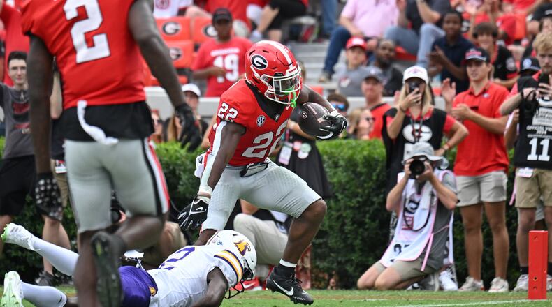 Georgia running back Branson Robinson (22) runs for a touchdown past Tennessee Tech defensive back James Edwards (2) during the second half in an NCAA football game at Sanford Stadium, Saturday, September 9, 2024, in Athens. Georgia won 48-3 over Tennessee Tech. (Hyosub Shin / AJC)