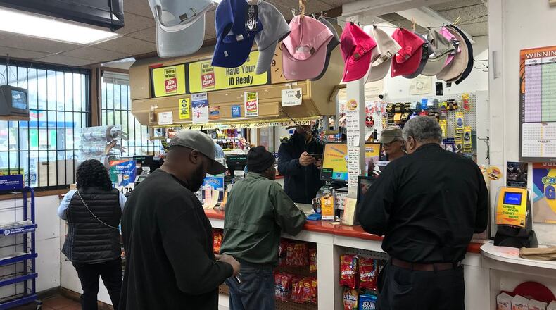 Players line up to buy lottery tickets.