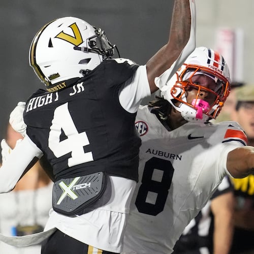 FILE - Auburn wide receiver Cam Coleman (8) catches a touchdown pass in the end zone past Vanderbilt cornerback Martel Hight (4) during the second half of an NCAA college football game, Nov. 8, 2025, in Nashville, Tenn. (AP Photo/George Walker IV, File)