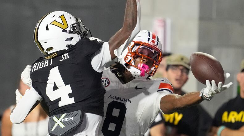 FILE - Auburn wide receiver Cam Coleman (8) catches a touchdown pass in the end zone past Vanderbilt cornerback Martel Hight (4) during the second half of an NCAA college football game, Nov. 8, 2025, in Nashville, Tenn. (AP Photo/George Walker IV, File)