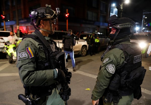 Police stand guard outside the Medicentro hospital where Colombian senator and presidential candidate Miguel Uribe Turbay is being treated after he was shot during a campaign rally in Bogota, Colombia, Saturday, June 7, 2025. (AP Photo/Jhon Wilson Vizcaino)