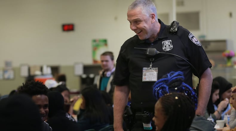 DeKalb County School District school resource officer Johnny Burnette wears a  body camera that captures 360-degree views while he speaks with students at Clarkston High School. The district launched a body-worn camera pilot program in March. ELIJAH NOUVELAGE/SPECIAL