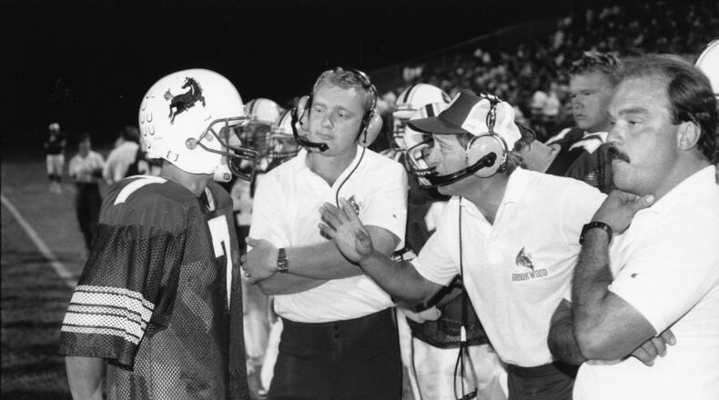 Former Brookwood High School football coach Dave Hunter (center right in headset). AJC file photo