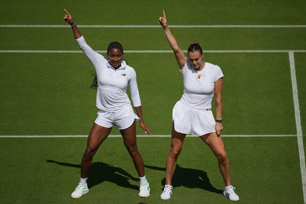 Aryna Sabalenka of Belarus, right, and Coco Gauff of United States dance during a practice session ahead of the Wimbledon Championships in London, Friday, June 27, 2025. (AP Photo/Kin Cheung)