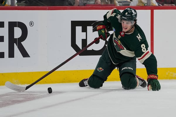 Minnesota Wild defenseman Zeev Buium controls the puck during the second period of Game 3 of a first-round NHL hockey playoff series against the Vegas Golden Knights, Thursday, April 24, 2025, in St. Paul, Minn. (AP Photo/Abbie Parr)