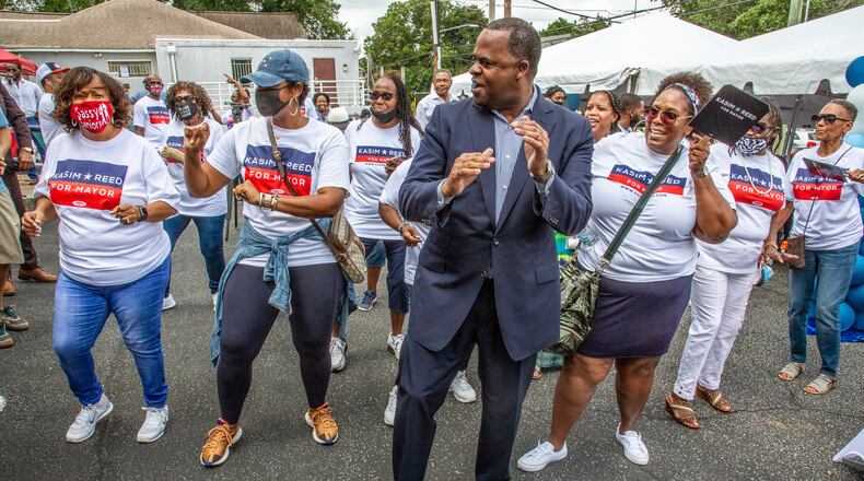 Former mayor Kasim Reed line dances with some of his volunteers at the opening of his new campaign headquarters in Atlanta Sunday, August 15, 2021.STEVE SCHAEFER FOR THE ATLANTA JOURNAL-CONSTITUTION