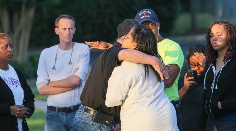 Family members and friends embrace at the scene where pedestrian was killed on Thorton Road.