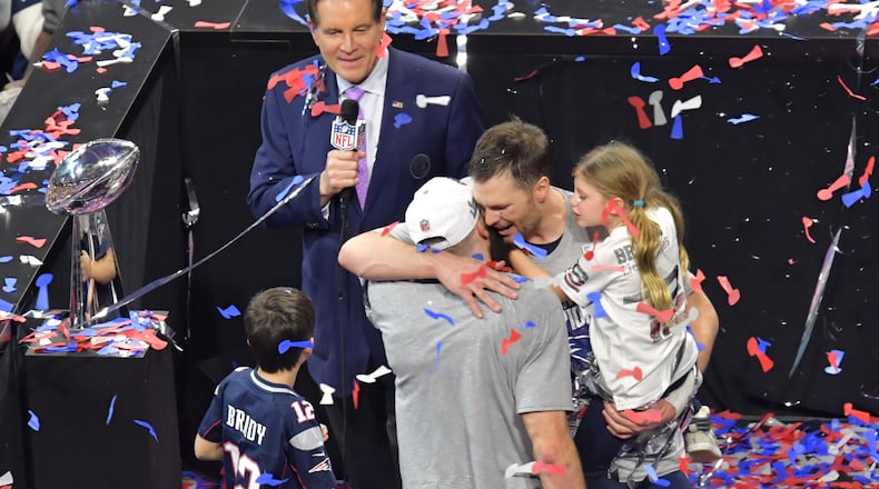 New England Patriots quarterback Tom Brady (12), with his children, hugs teammate Julian Edelman after the Patriots’ win over the Los Angeles Rams in Super Bowl LIII Feb. 3, 2019, at the Mercedes-Benz Stadium in Atlanta.