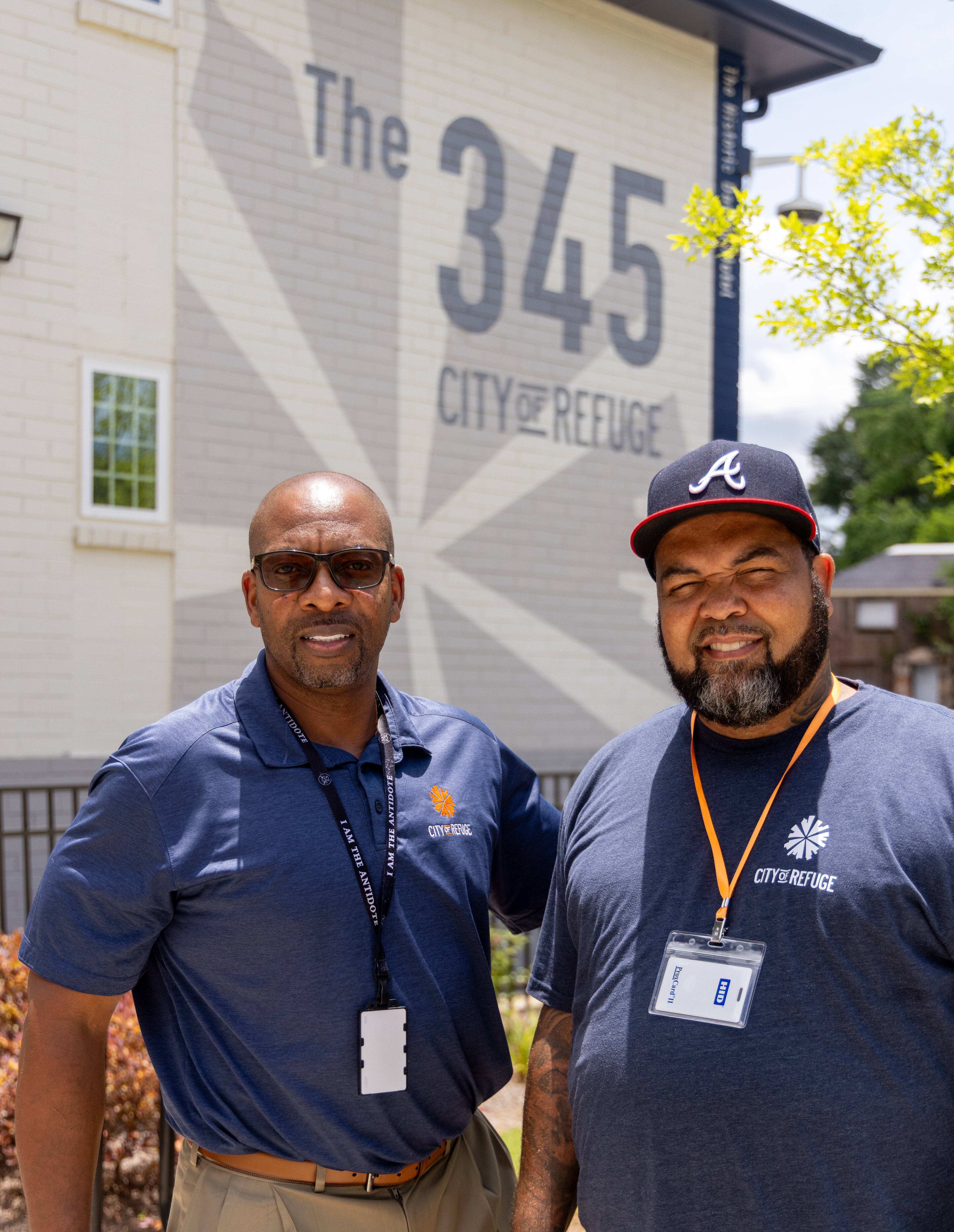 Greg Washington (left) leads the reentry program at The 345, the City of Refuge's transitional housing program for men. QuinKnoca Owens (right) lives there and is the intake coordinator of The 345, where he's the first face new residents see when they arrive at the building. (Phil Skinner for the AJC)