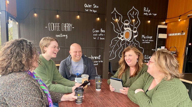 Members of the Just One More Page Book Club discuss good books they've read lately. The club meets at the Marietta Coffee Shop and is for readers who aren’t looking for any personal connections outside of the club. Courtesy of Dana DiLorenzo