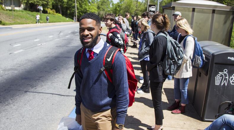 Destin Mizelle, a third year psychology student at the University of Georgia and newly elected Student Government Association treasurer, waits for a bus on the University of Georgia campus in Athens, Georgia, on Tuesday, April 17, 2018. (REANN HUBER/REANN.HUBER@AJC.COM)